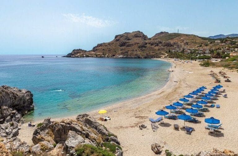 Beach with sun loungers and clear blue sea